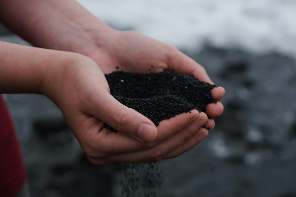 person holding black soil person holding black soil