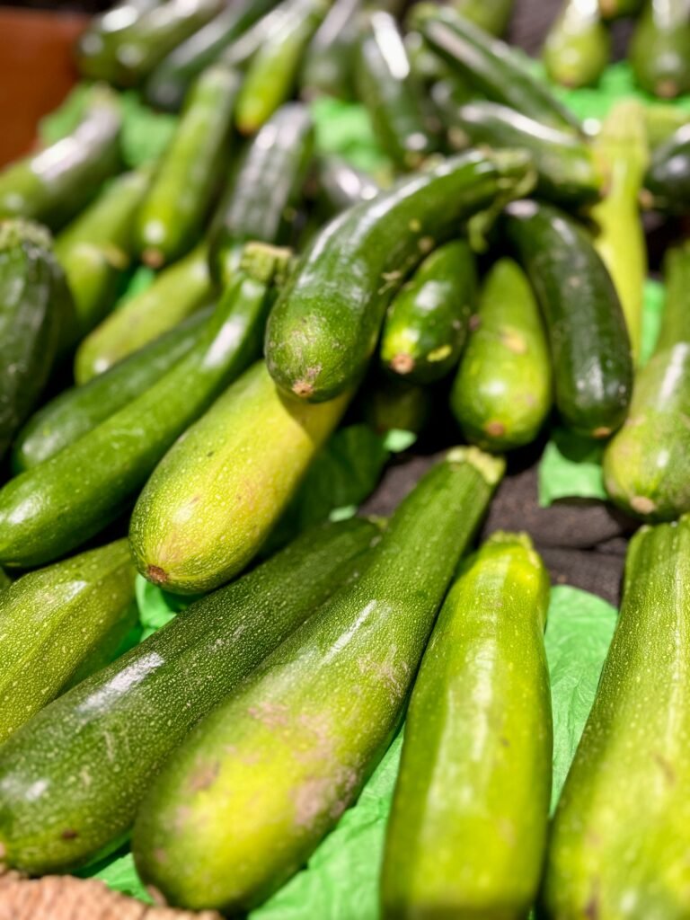 A bunch of cucumbers sitting on top of a table A bunch of cucumbers sitting on top of a table