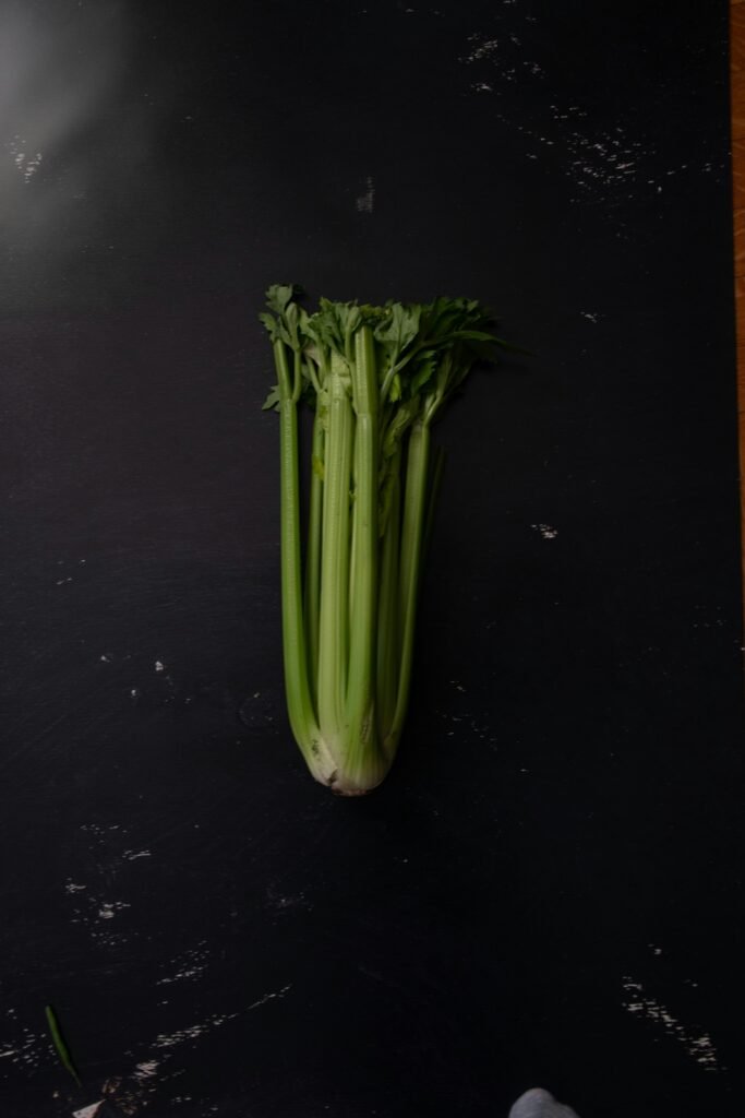 green vegetable on black table Staudensellerie
