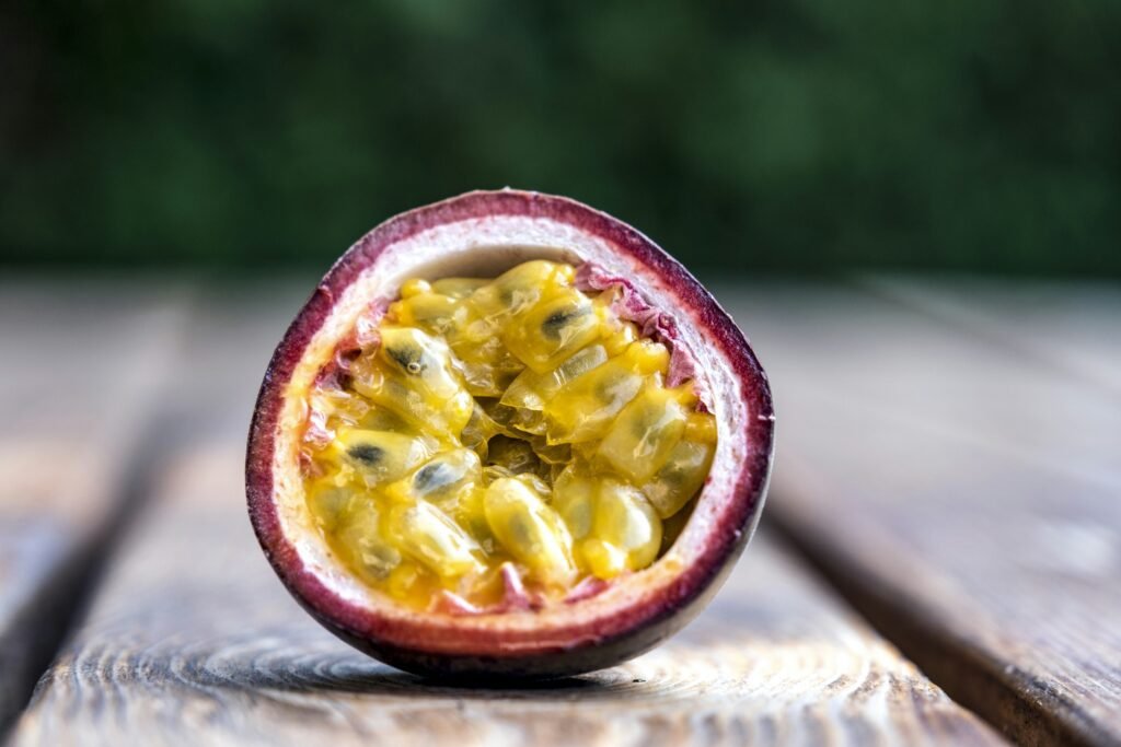 red and yellow round fruit on brown wooden table red and yellow round fruit on brown wooden table