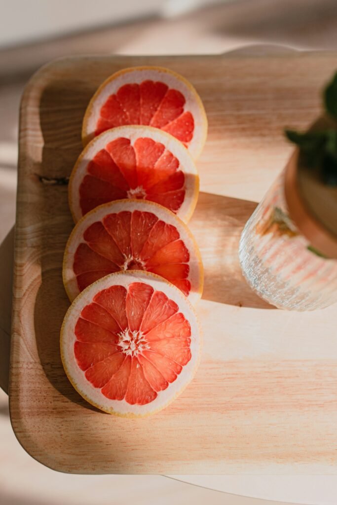 sliced orange fruit on brown wooden chopping board sliced orange fruit on brown wooden chopping board