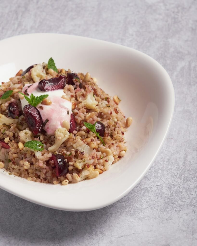 a white bowl filled with food on top of a table